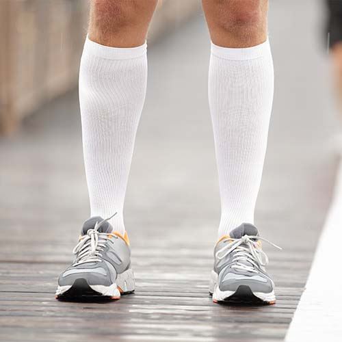 Patient walking with compression socks image
